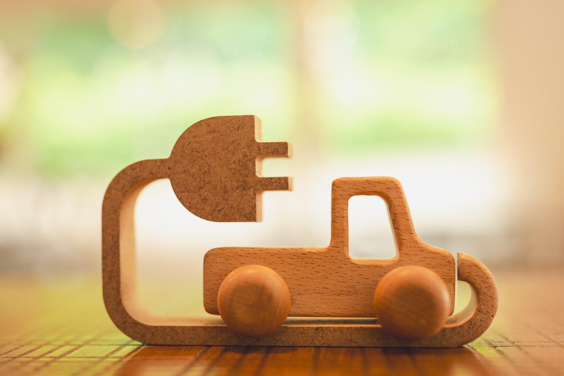 Wooden car with wires and lithium battery, Technology battery high power electric energy with a connected charging cable. Battery to electric cars and mobile devices with clean electric.